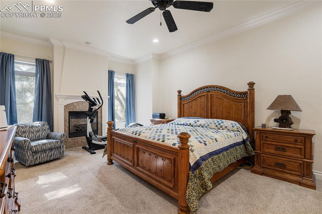 Primary bedroom on the main level with crown molding.  