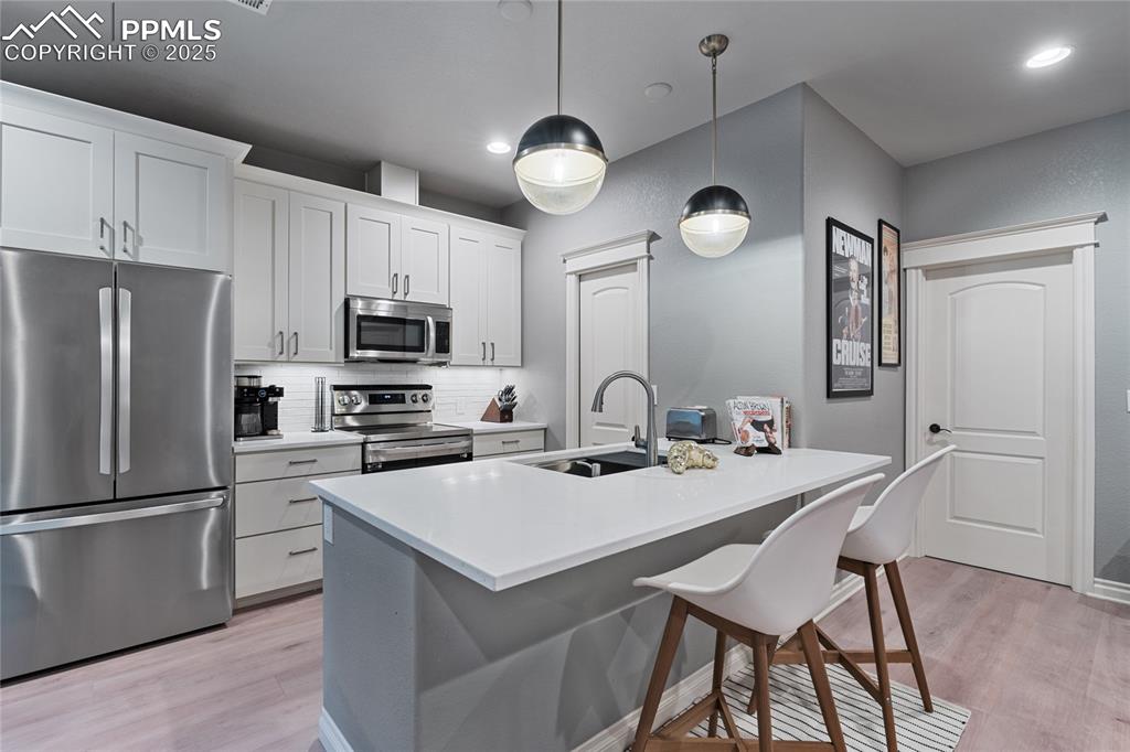 Full size refrigerator with space to eat at the island.