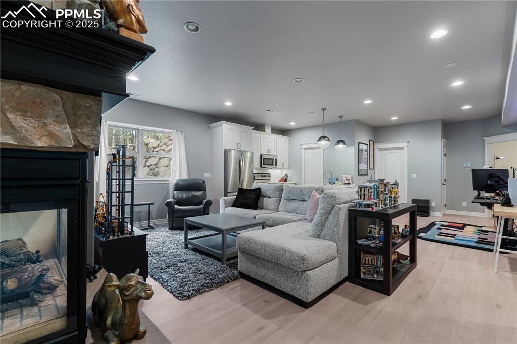 The dual sided fireplace seperates the golf/media space from another large living or rec area.  Lots of game tables can fit here.