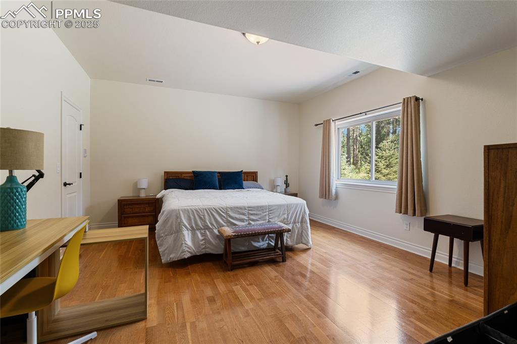 Bedroom featuring wood finished floors and baseboards