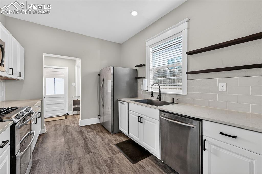 Large kitchen with quartz countertops and under-cabinet lighting