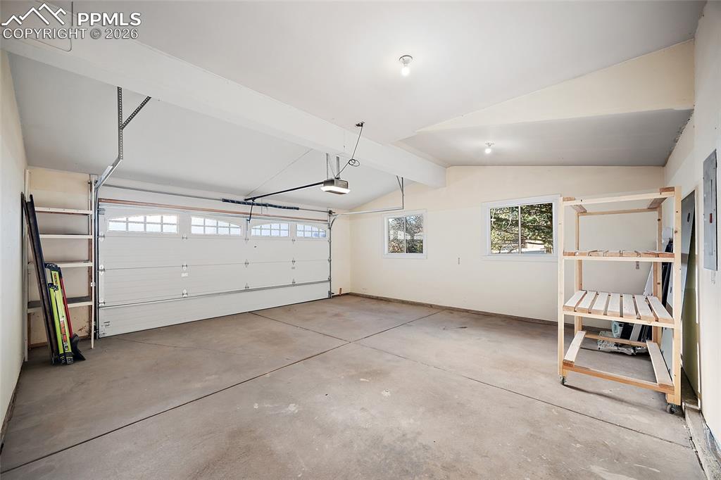 Large oversized finished garage with storage shelving