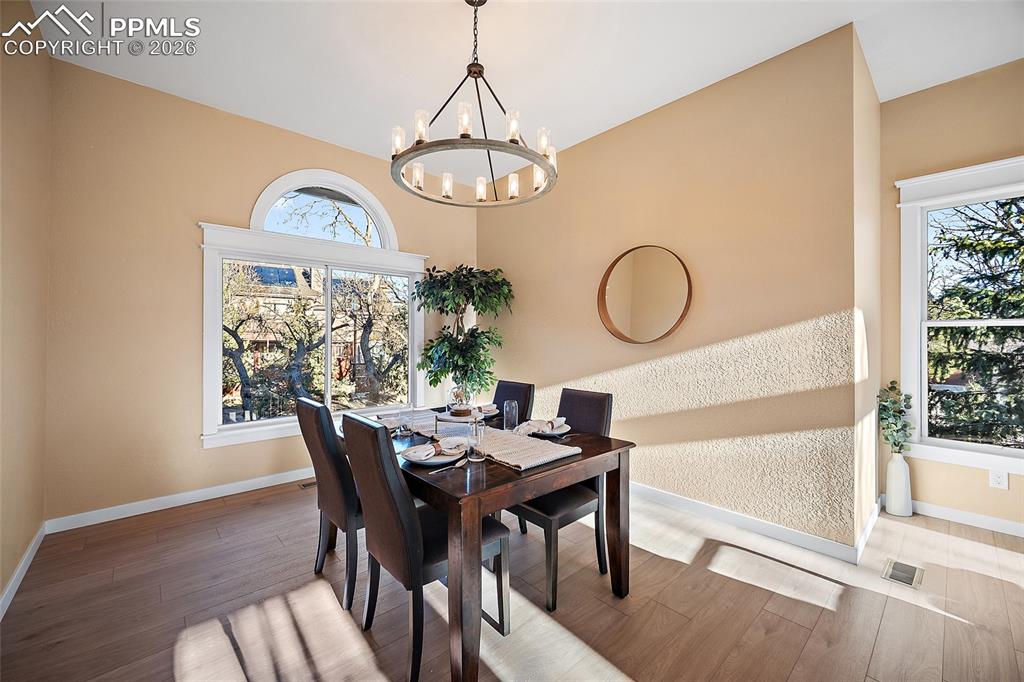 Dining area featuring new LVP flooring and a new dining chandelier