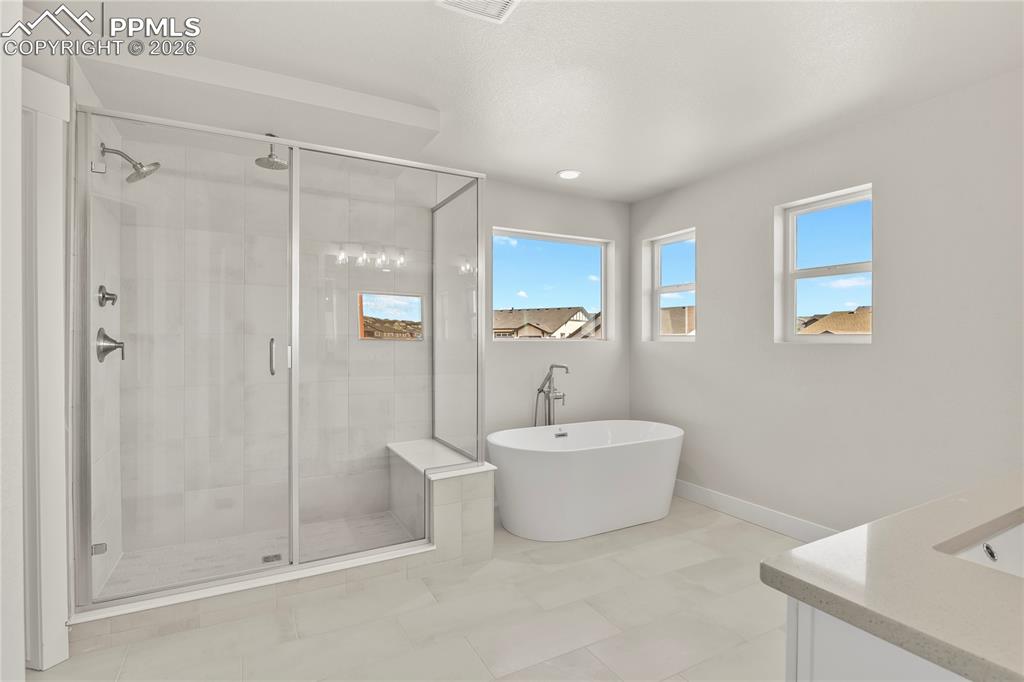 Five-piece bath finished with soaker tub and large shower with bench