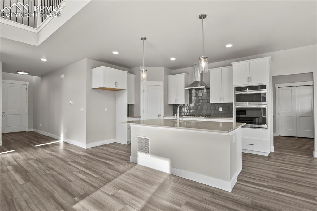 Kitchen equipped with wall oven, gas cooktop, and pantry