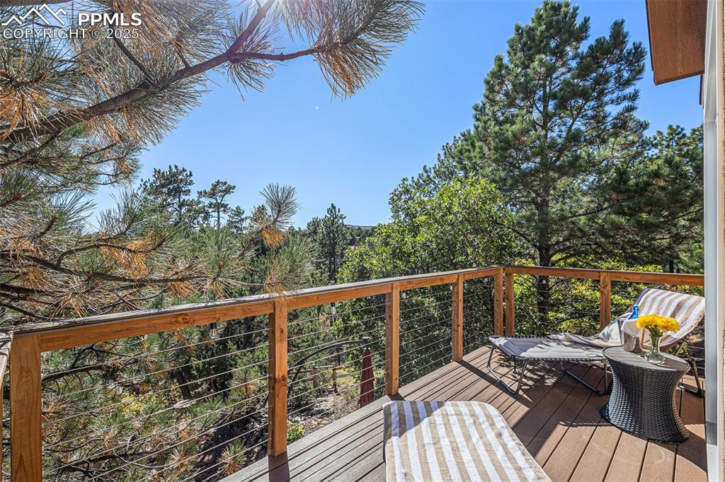 Bathroom featuring a textured wall, double vanity, dark wood-type flooring, a freestanding bath, and tile walls