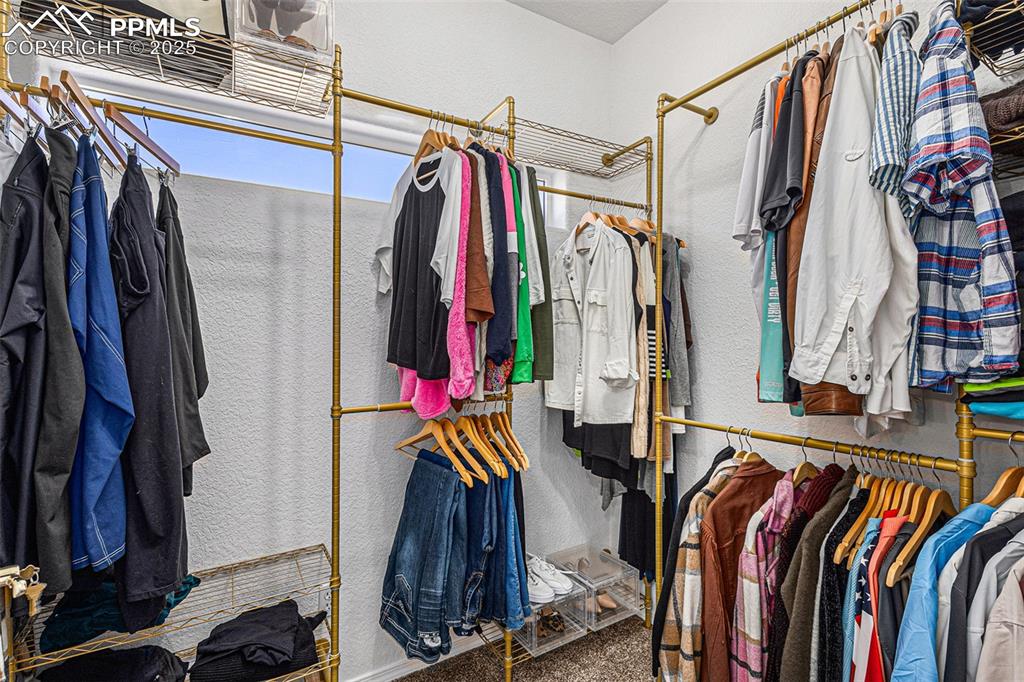 Stairs featuring lofted ceiling, a chandelier, and wood finished floors