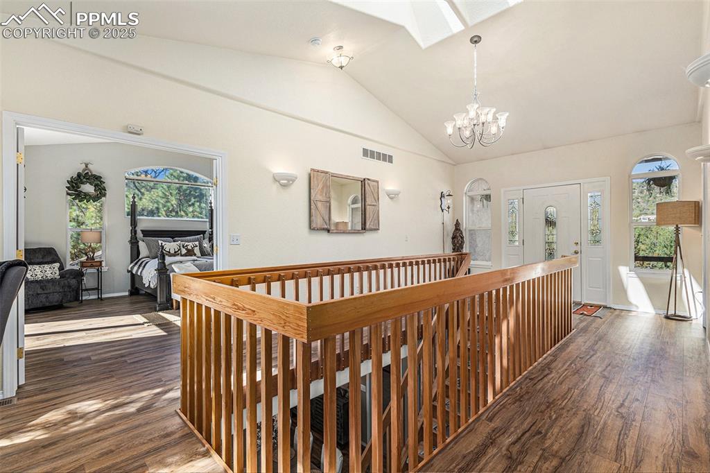 View of front of house with a shed, stucco siding, concrete driveway, an attached garage, and a tile roof