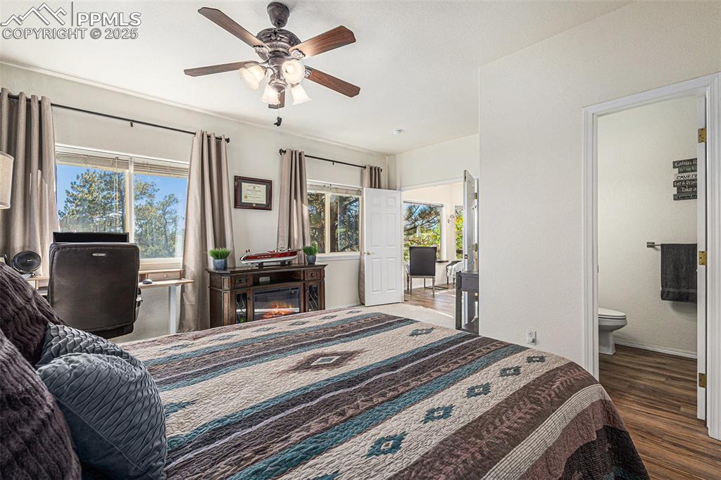 Bedroom featuring dark wood finished floors, a ceiling fan, and a closet