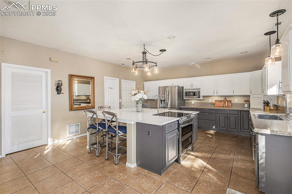 Living room with a wood stove, high vaulted ceiling, wood finished floors, recessed lighting, and ceiling fan