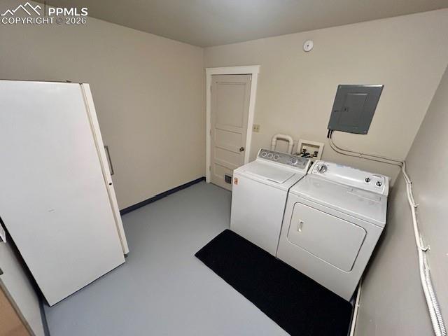 laundry room with heat, washer, dryer and freezer included