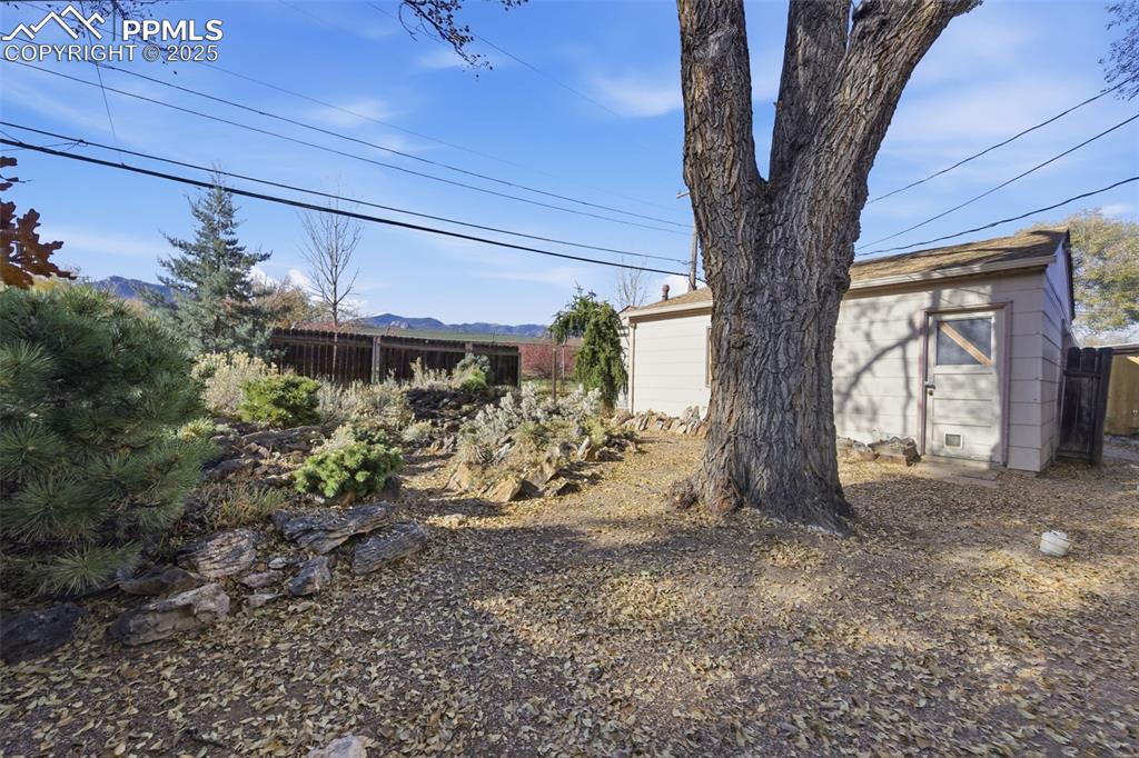 View of yard with an outdoor structure and a mountain view