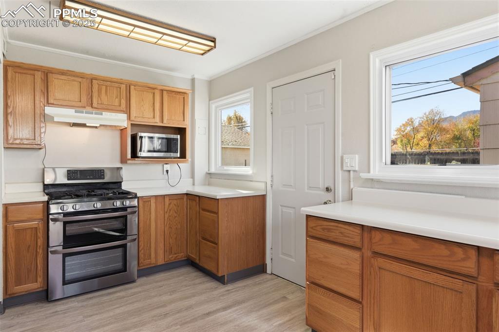 Kitchen with stainless steel appliances, light countertops, 