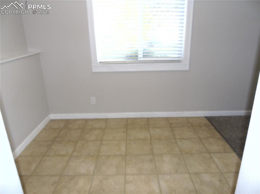 Spare room featuring baseboards