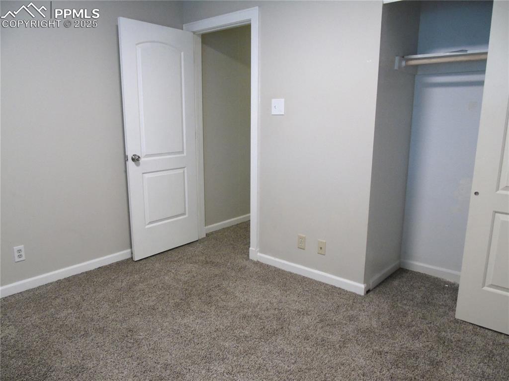 Unfurnished bedroom with carpet floors and a closet