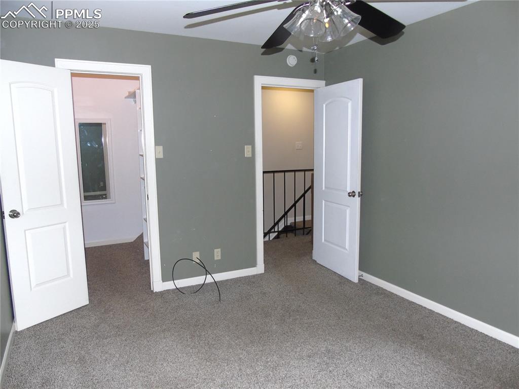Unfurnished bedroom with carpet floors and a ceiling fan