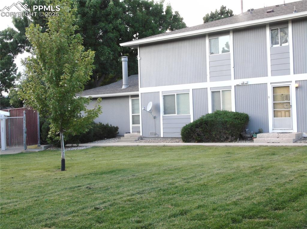 Rear view of property with roof with shingles