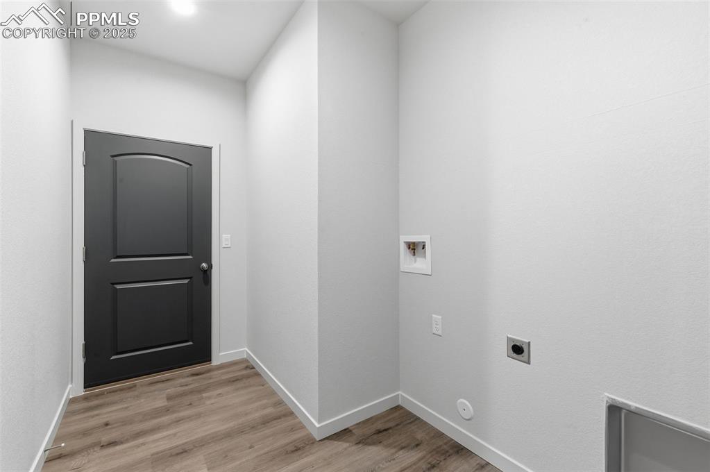 Laundry area with washer hookup, light wood finished floors, and hookup for an electric dryer