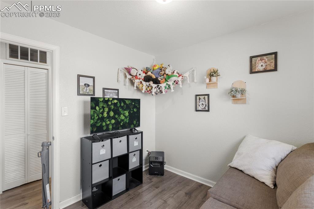 Sitting room featuring baseboards and wood finished floors