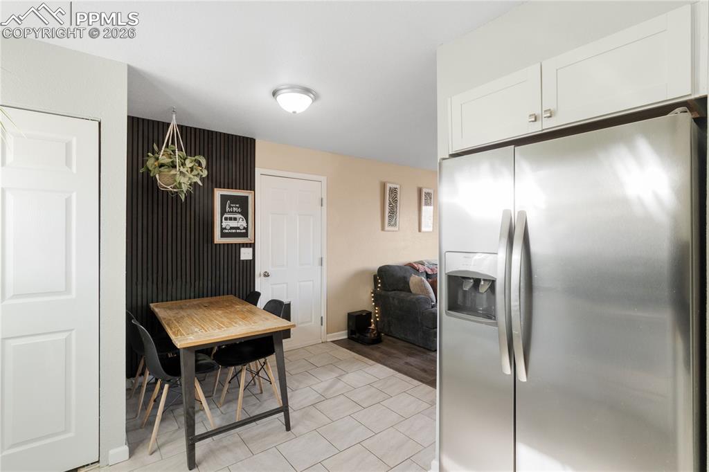Dining area with baseboards and light tile patterned floors