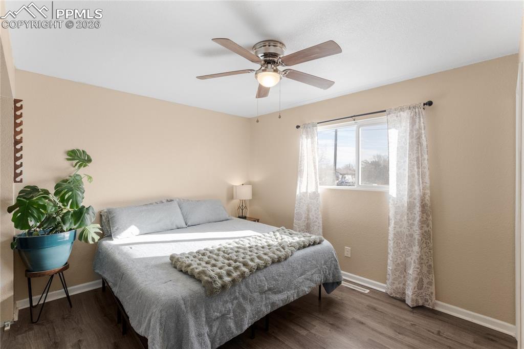 Bedroom featuring dark wood-style flooring and a ceiling fan