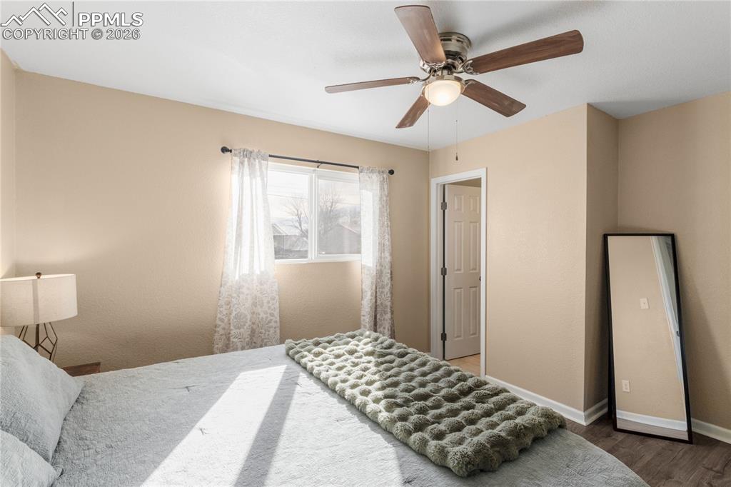Bedroom with a ceiling fan and wood finished floors