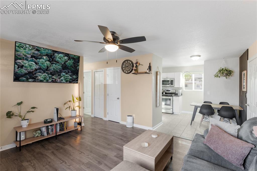 Living room featuring light wood finished floors and a ceiling fan