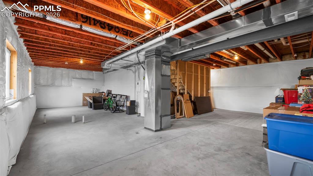 Unfinished basement featuring heating unit