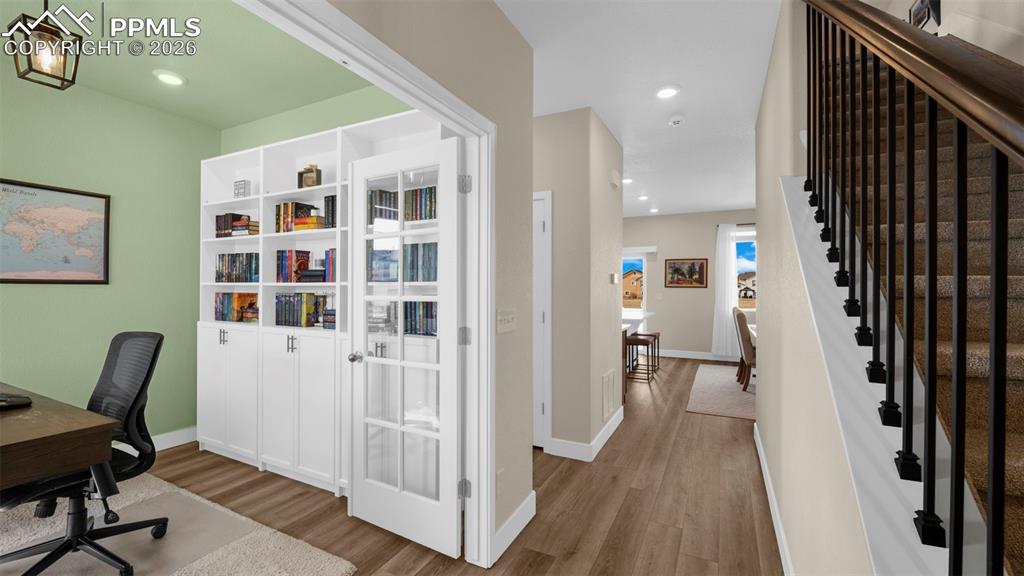 Office area featuring wood finished floors and recessed lighting