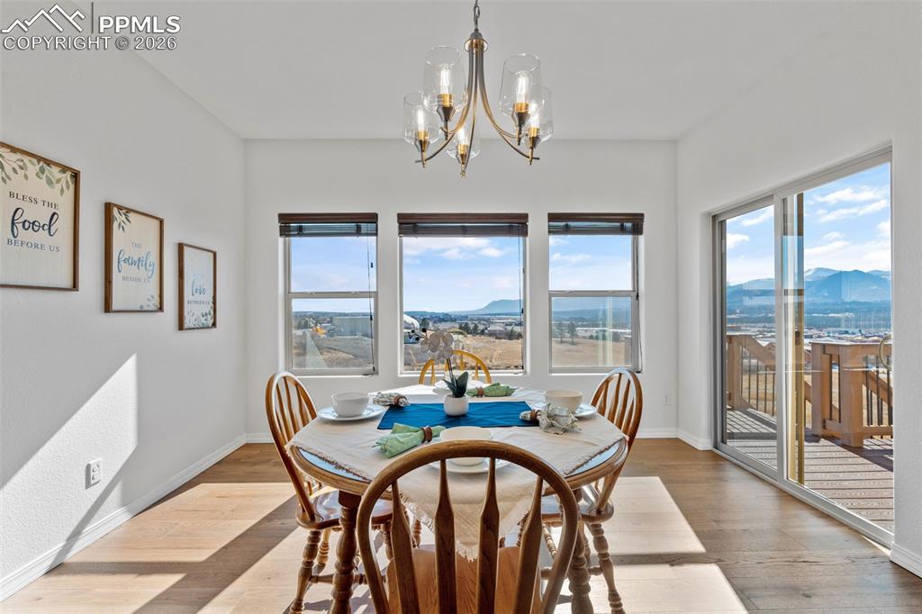 Dining space featuring a mountain view, hardwood / wood-style floors, and a chandelier