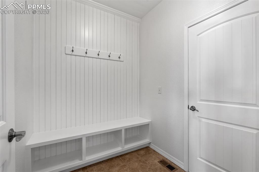 Mudroom with baseboards and tile patterned floors