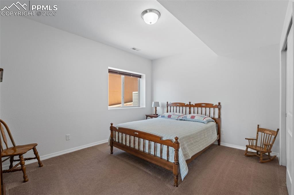 Bedroom featuring carpet floors and baseboards