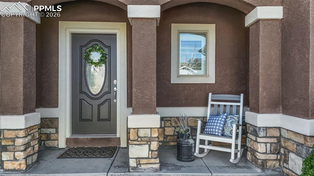 Property entrance with stucco siding