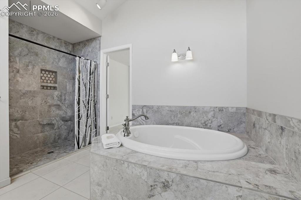 Soaking tub and walk-in shower in primary bathroom.
