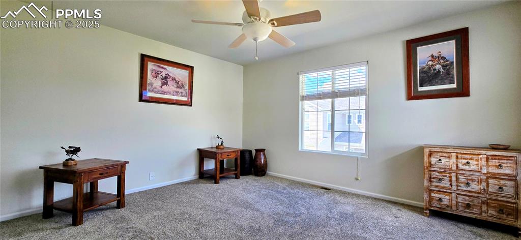 Sitting room featuring carpet floors and a ceiling fan