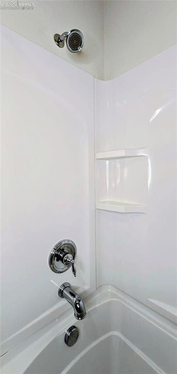 Bathroom view of tub / shower combination