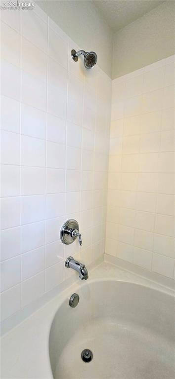 Bathroom featuring washtub / shower combination