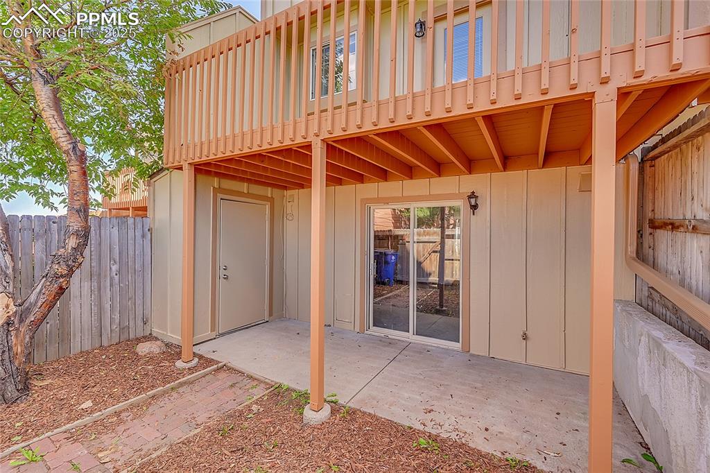 View of patio / terrace with fence & added storage closet