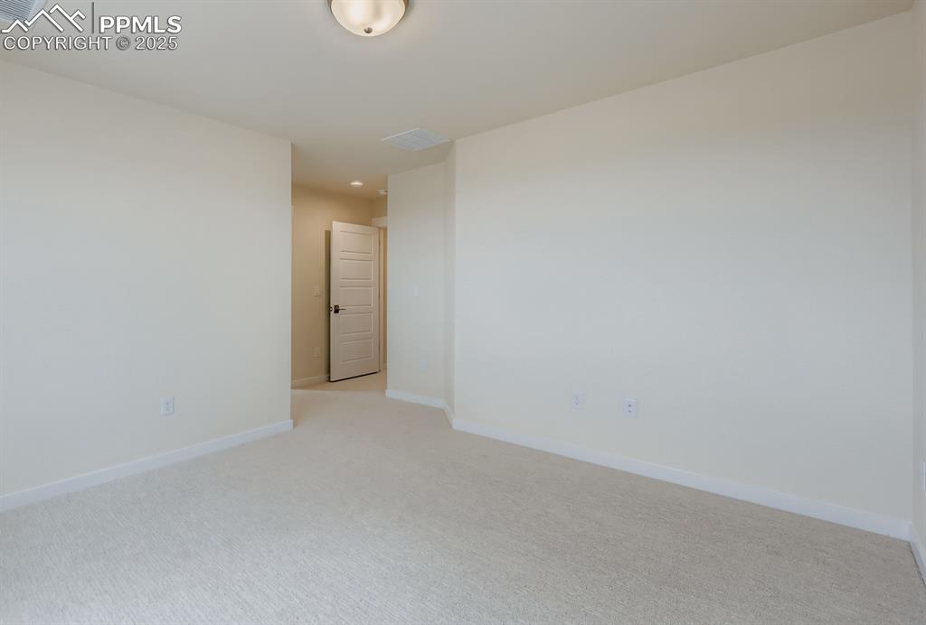 Unfurnished room featuring light colored carpet