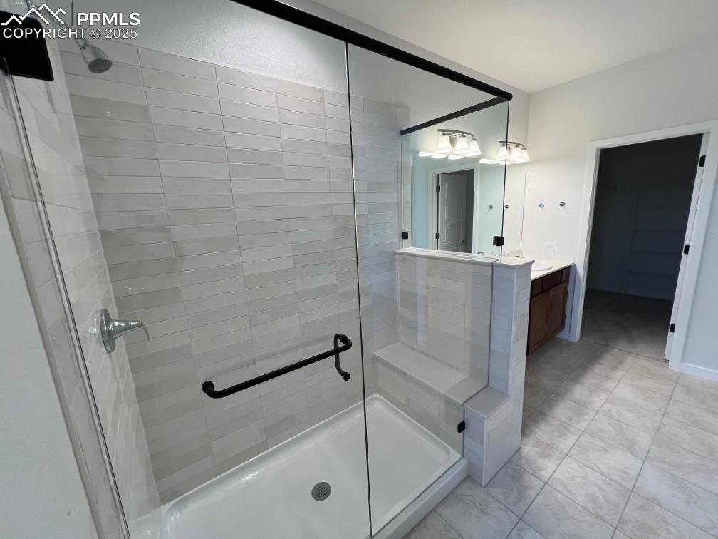 Full bathroom with a stall shower and vanity