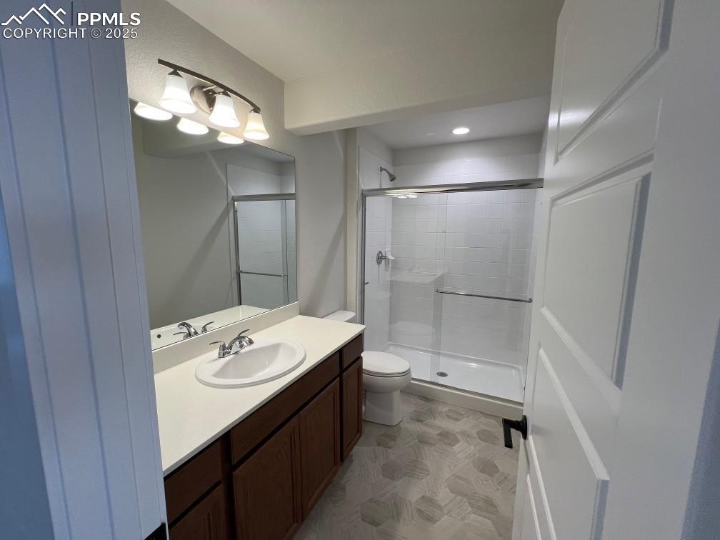 Bathroom featuring vanity, a shower stall, and recessed lighting