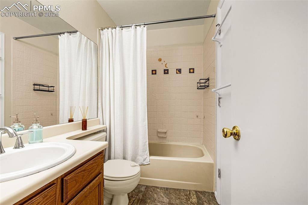 Full bath featuring shower / tub combo and vanity