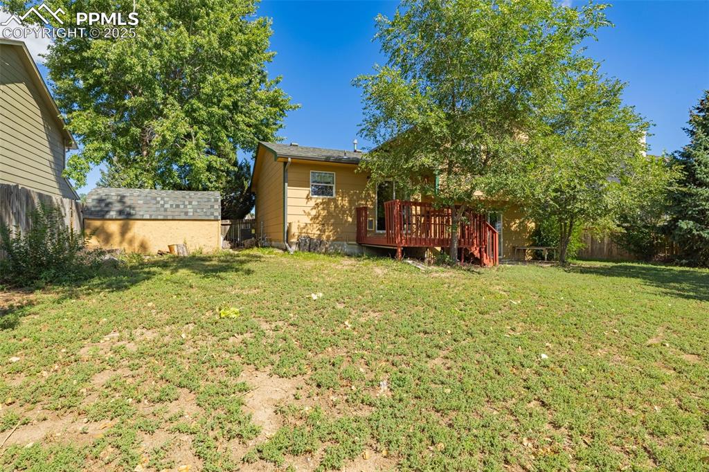 View of yard with a wooden deck