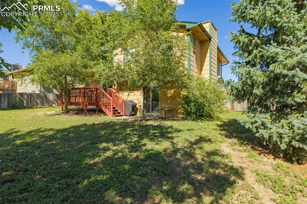 View of yard with stairway and a wooden deck