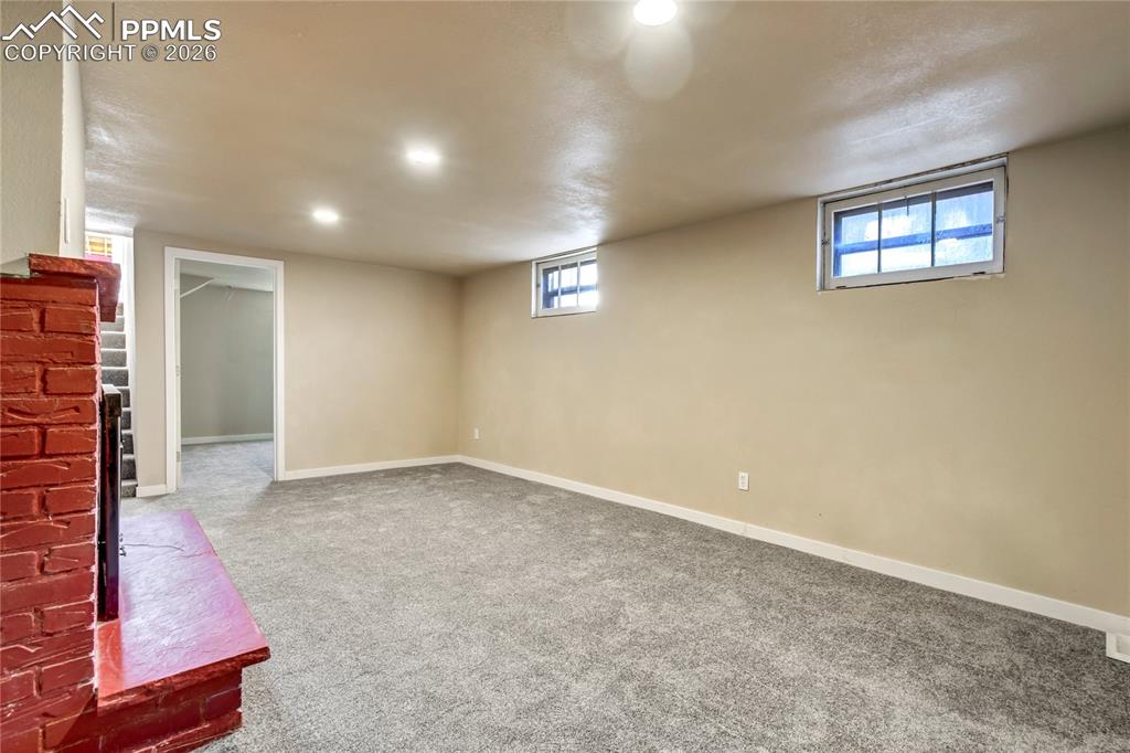 Family room with wood burning fireplace.