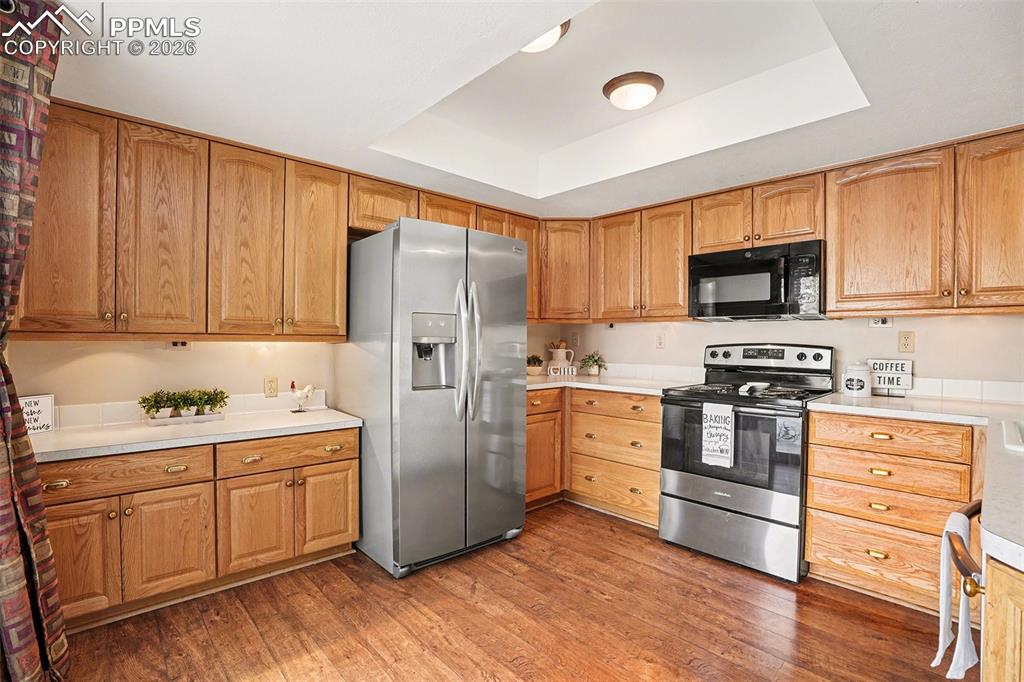 Spacious, well-appointed kitchen offering ample counter and cabinet space, ideal for everyday living and entertaining. Convenient walk-out access to the patio provides seamless indoor-outdoor flow, perfect for enjoying morning coffee, outdoor dining, or relaxing in the fresh air.