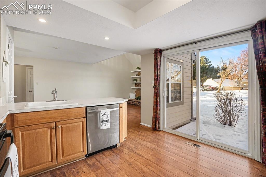 Spacious, well-appointed kitchen offering ample counter and cabinet space, ideal for everyday living and entertaining. Convenient walk-out access to the patio provides seamless indoor-outdoor flow, perfect for enjoying morning coffee, outdoor dining, or relaxing in the fresh air.