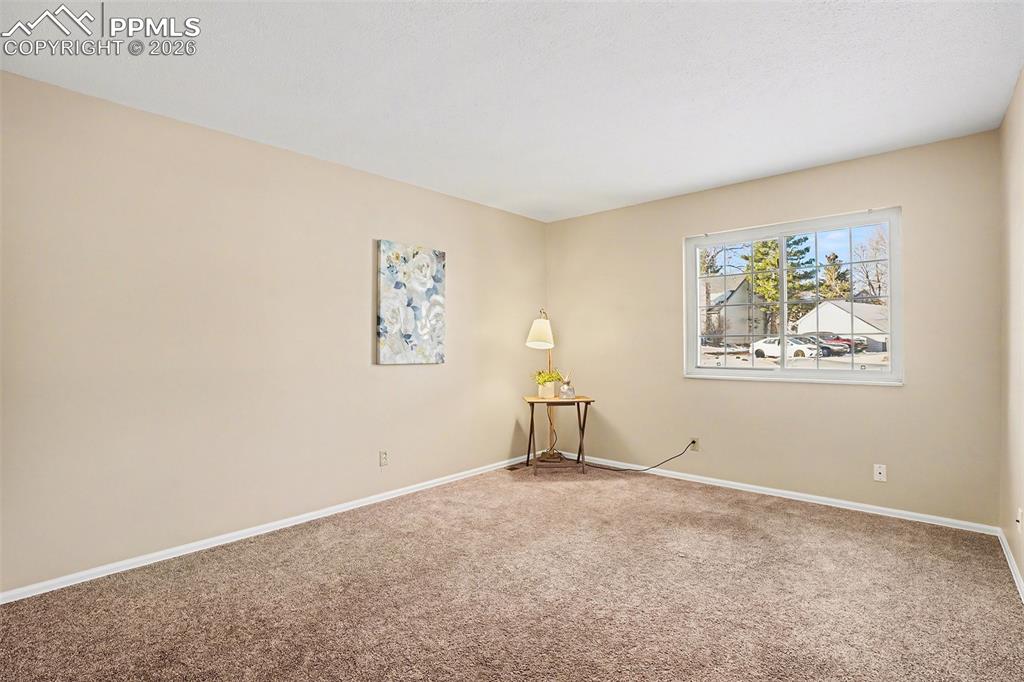 Light and bright main level bedroom featuring an open, airy layout and abundant natural light. Includes a spacious walk-in closet offering excellent storage and organization, creating a comfortable and functional retreat.