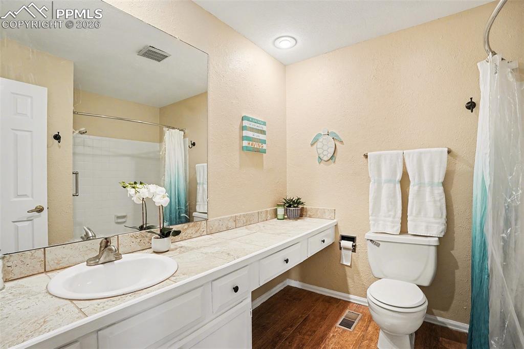 Open and well-designed main level full bathroom featuring a functional layout with ample space, offering comfort and convenience for guests or main-level living.