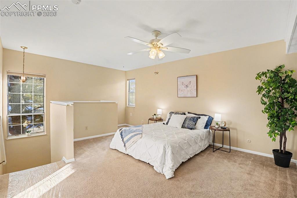 Spacious and bright primary bedroom located on the upper level, featuring an open loft-style layout with abundant natural light. Includes a generous walk-in closet, creating a comfortable and inviting private retreat.